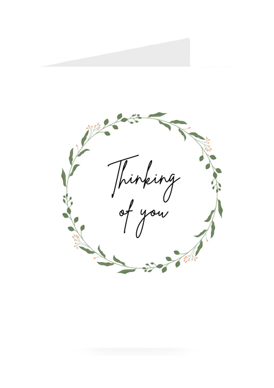 Circular wreath greeting card with 'Thinking of you' text on a white background
